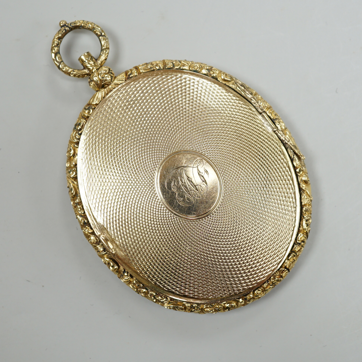 A Victorian engine turned yellow metal (tests as 9ct gold) oval pendant locket, housing a miniature on ivory depicting a lady, overall 7.75cm, gross 41 grams CITIES Submission reference, TVTSSFBX